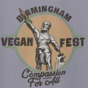 A circular logo reading “Birmingham Vegan Fest — Compassion For All,” featuring the Vulcan statue in the center holding a carrot instead of a spear.